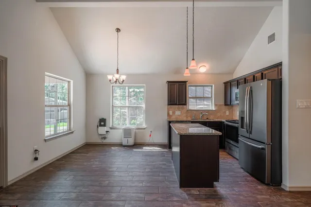 a kitchen with refrigerator and window