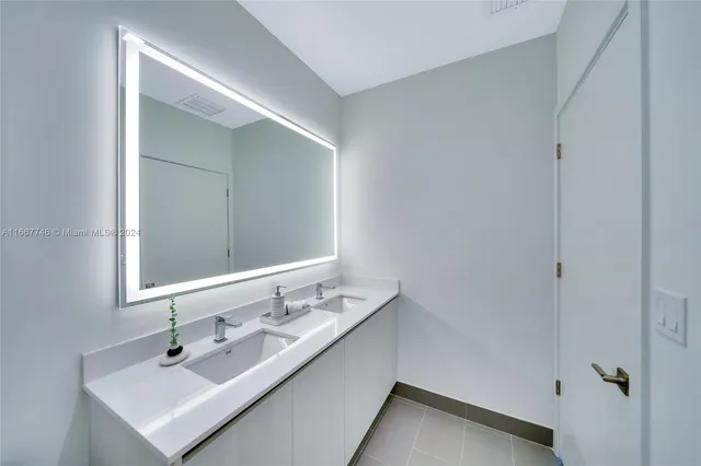 a living room with furniture and a lamp