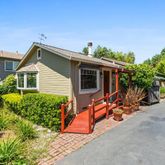 a view of a house with backyard and sitting area