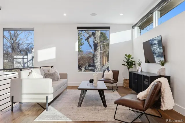 a living room with furniture lamp and a large window