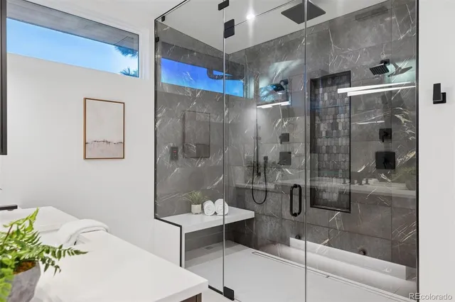 a bathroom with a shower and a sink