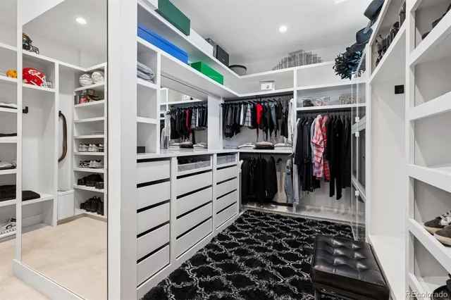 a kitchen with stainless steel appliances kitchen island granite countertop a refrigerator and a sink