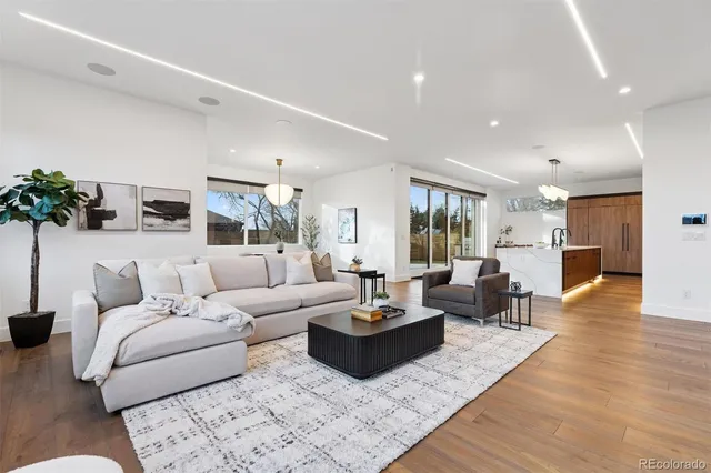 a living room with furniture kitchen view and a table