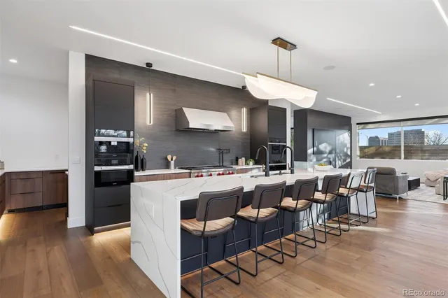 a living room with lots of furniture and kitchen view