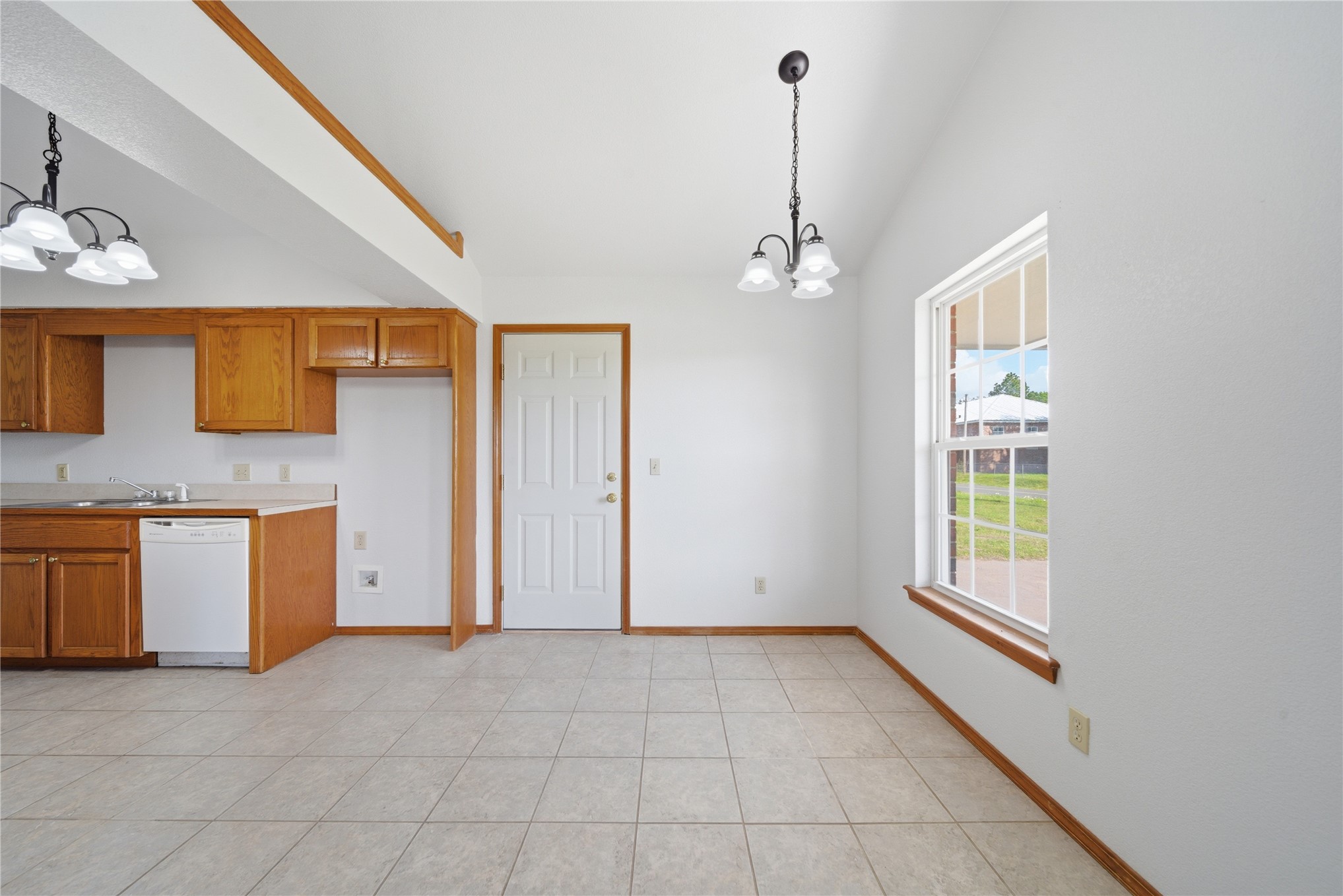 511 Cemetery Road Oktaha, OK 74450 - Photo 8 of 28 V-groove vaulted ceiling with a decorative chandelier, tile flooring, and a large window with a wood sill