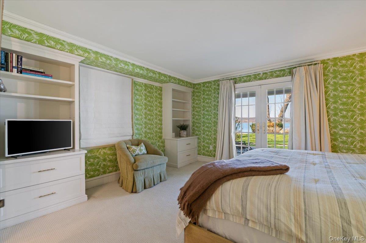 516 Centre Island Road Centre Island, NY 11771 - Photo 30 of 41 a bedroom with a bed a flat screen tv and balcony view