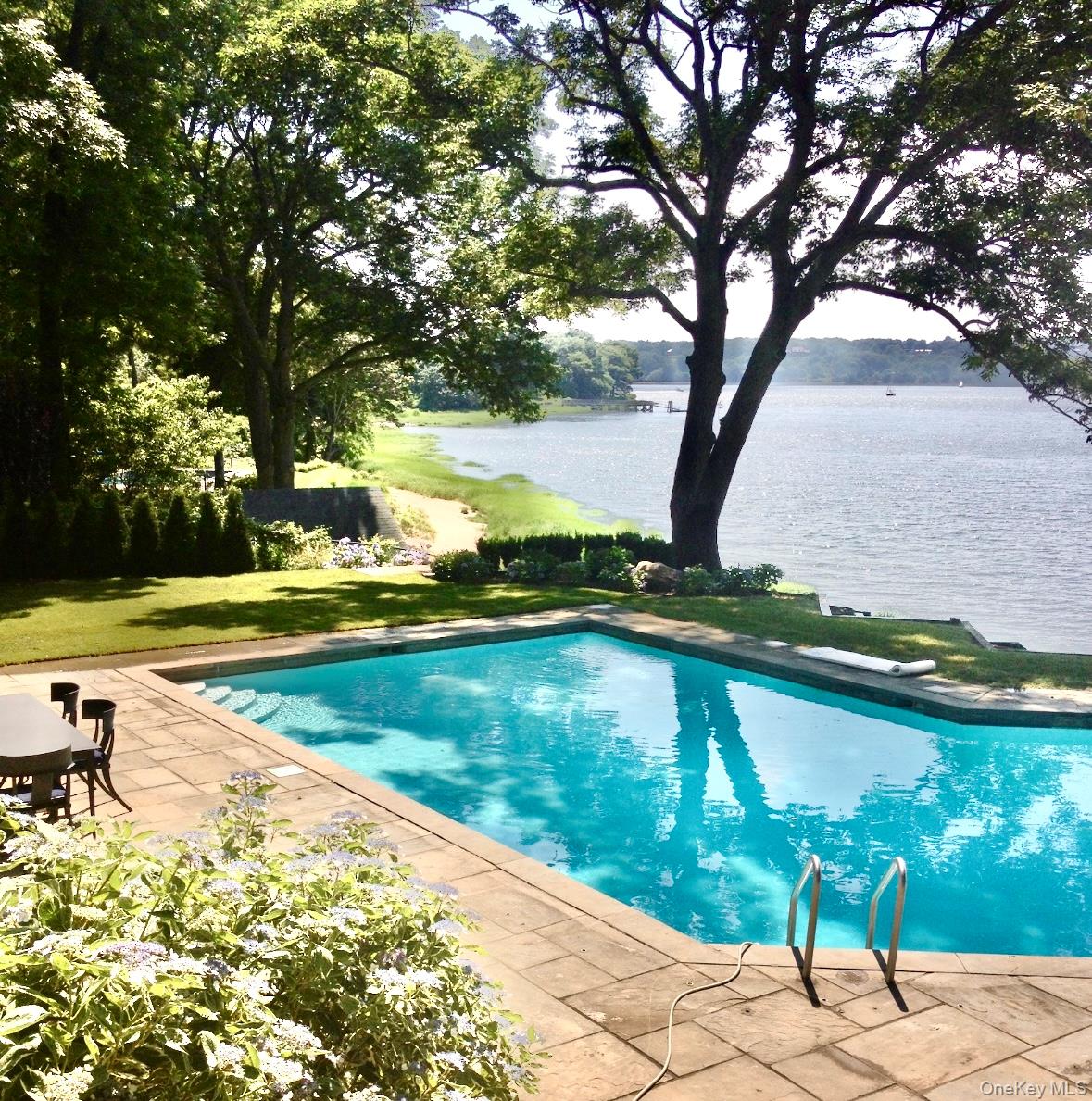 516 Centre Island Road Centre Island, NY 11771 - Photo 35 of 41 a view of swimming pool with lawn chairs and plants