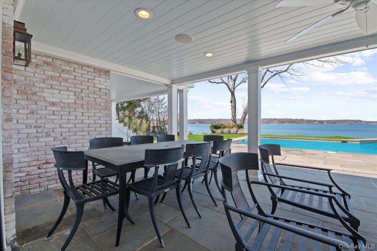 516 Centre Island Road Centre Island, NY 11771 - Photo 37 of 41 a view of a patio with a table chairs and a backyard