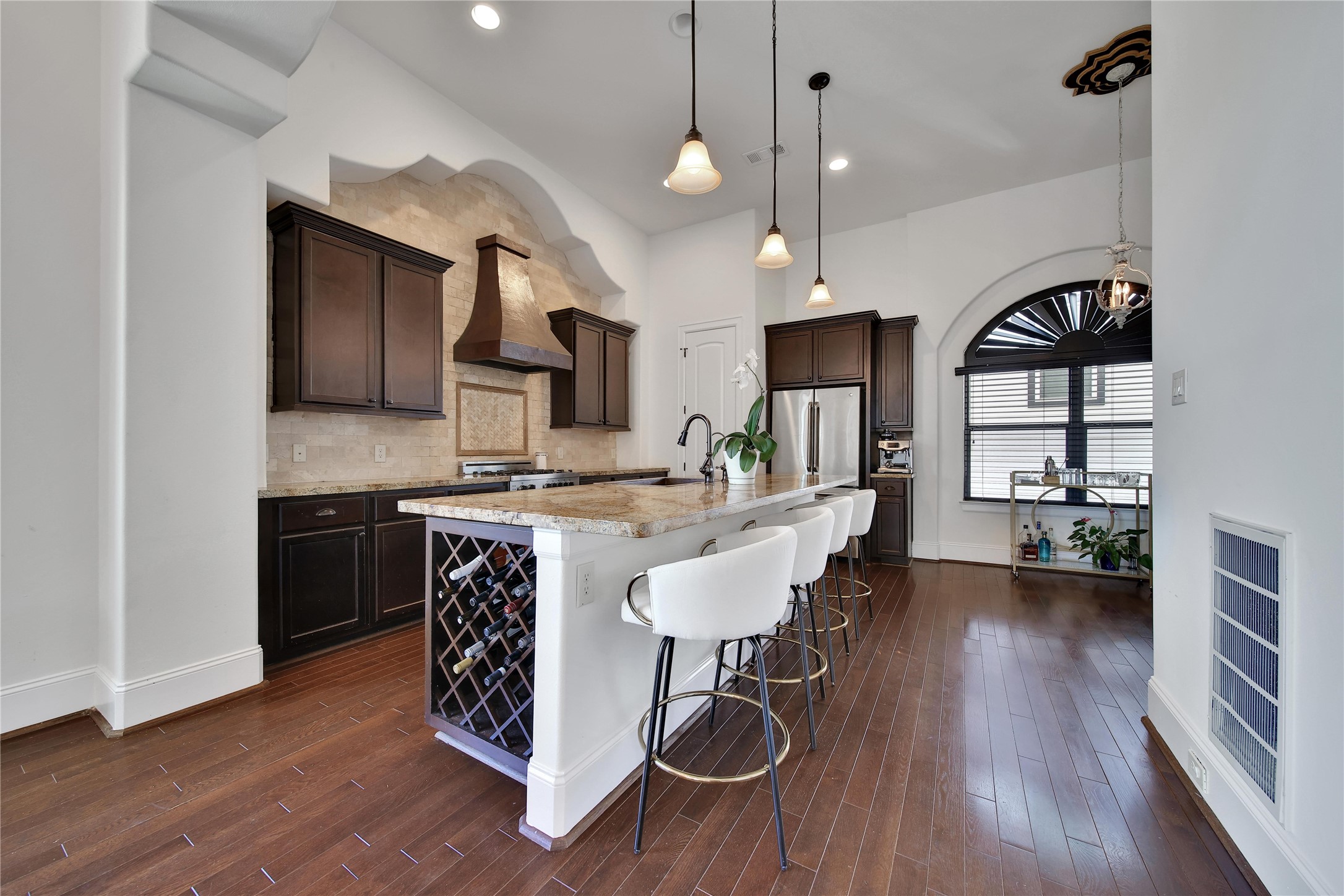 2301 Couch Street Houston, TX 77008 - Photo 13 of 22 a kitchen with kitchen island stainless steel appliances a dining table chairs sink and cabinets