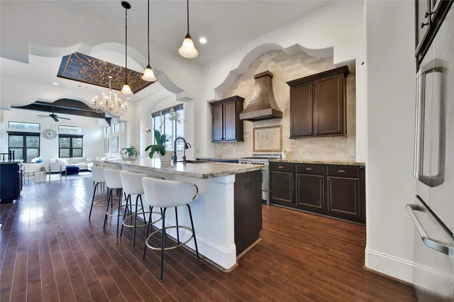 a kitchen with a counter space a sink appliances and cabinets