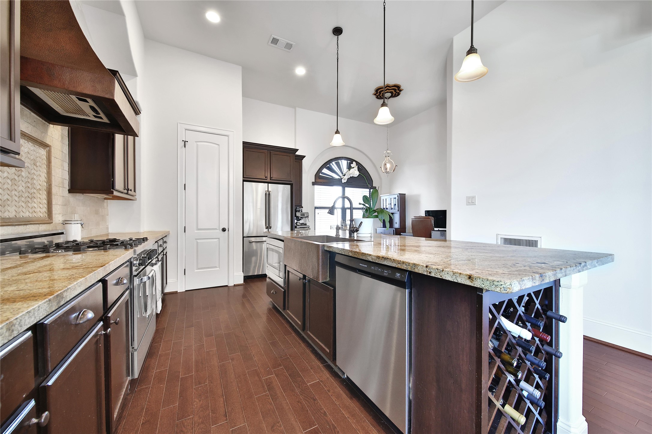 2301 Couch Street Houston, TX 77008 - Photo 16 of 22 a kitchen with a sink a counter space appliances and cabinets