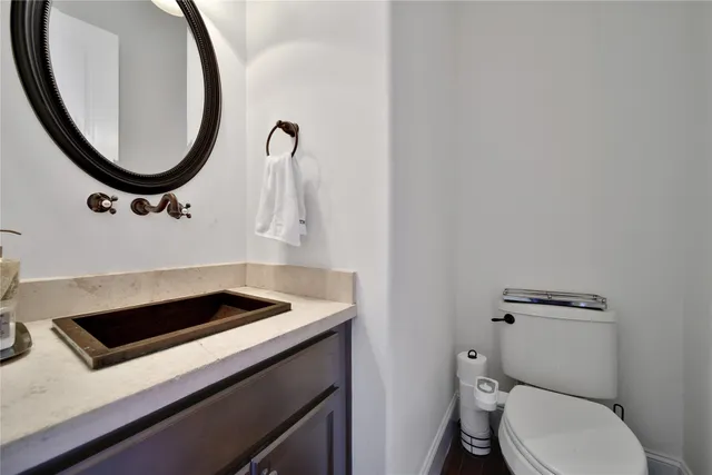 a bathroom with a toilet a sink and a mirror
