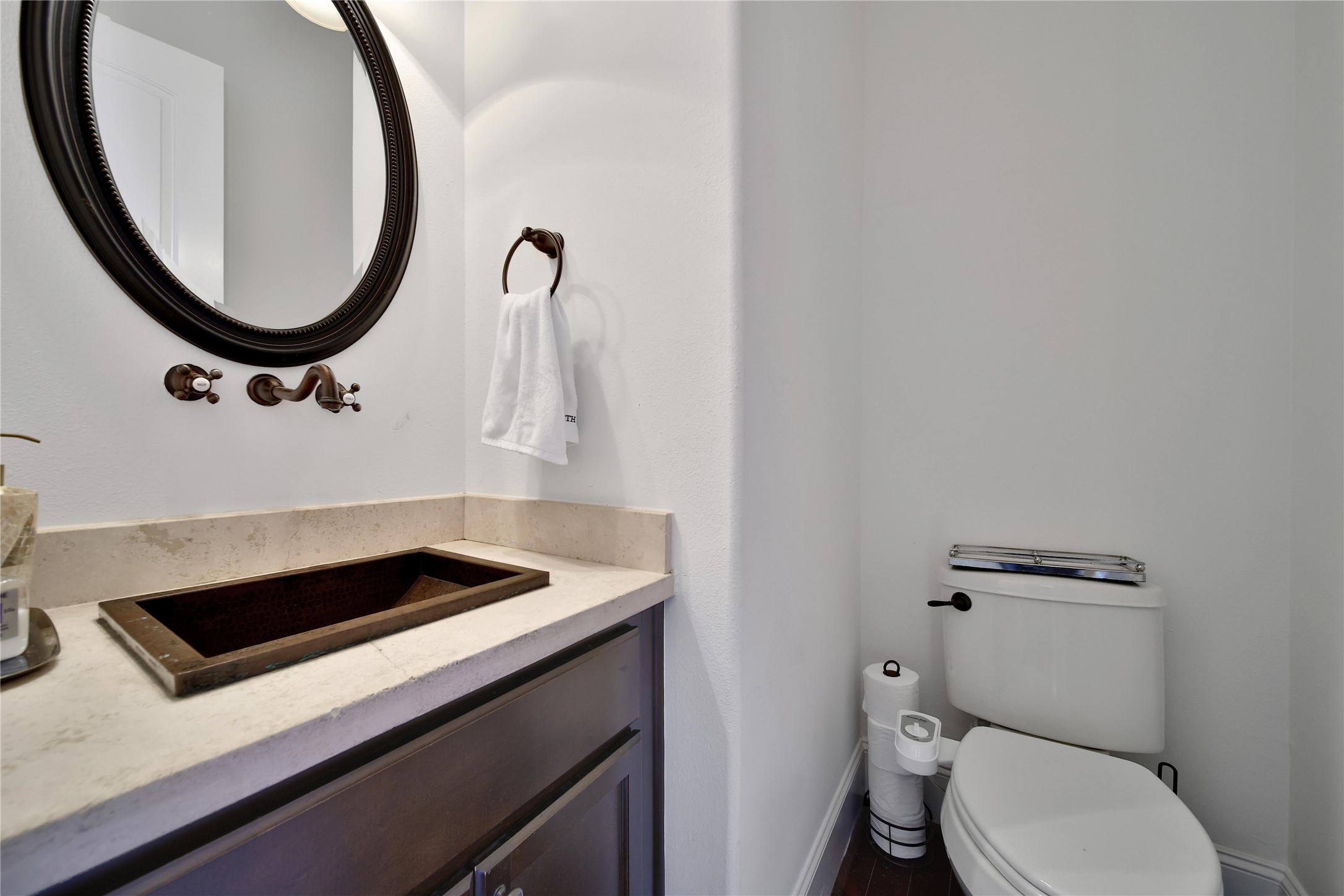 2301 Couch Street Houston, TX 77008 - Photo 17 of 22 a bathroom with a toilet a sink and a mirror
