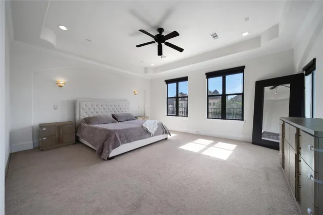 a spacious bedroom with a bed and a large window