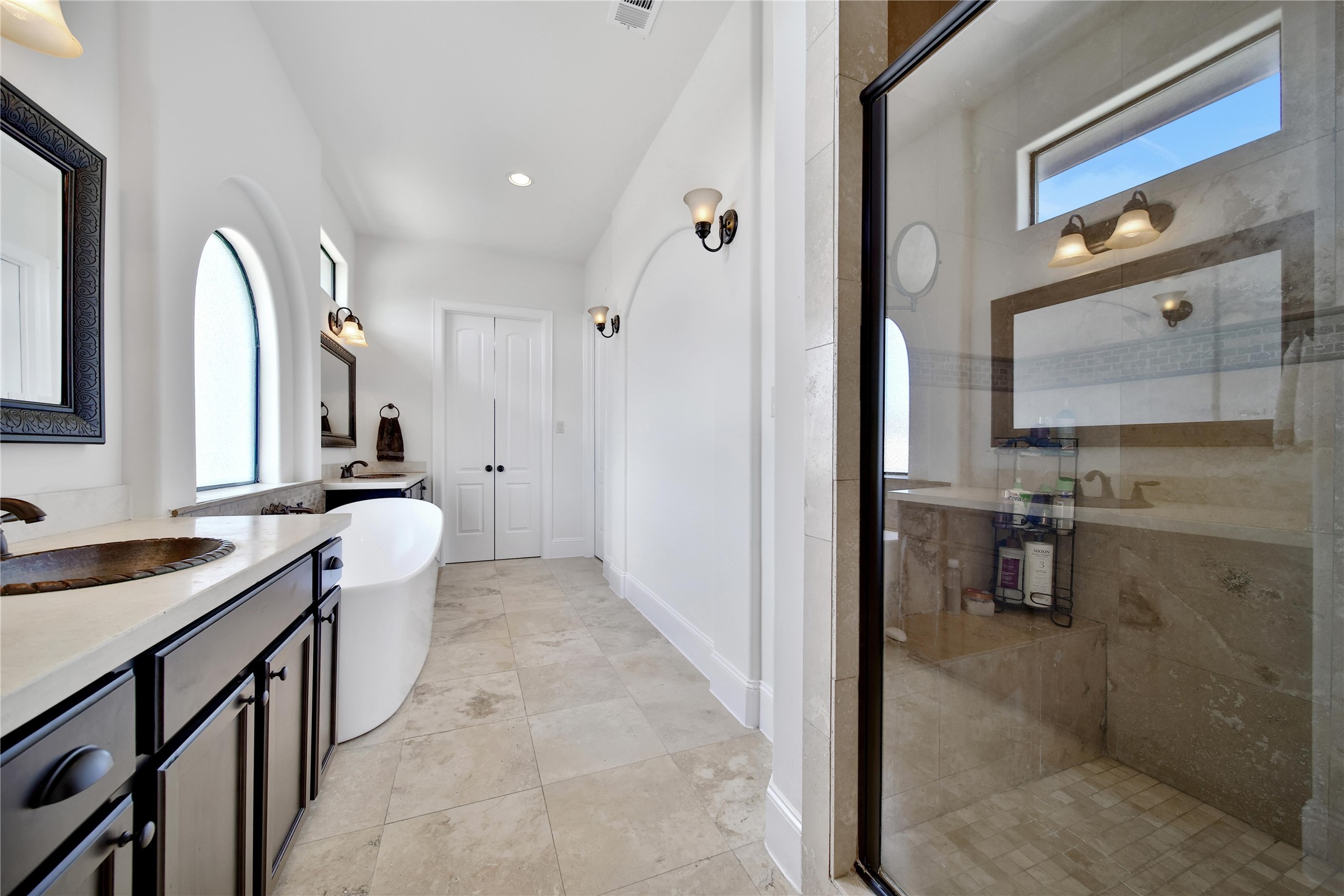 2301 Couch Street Houston, TX 77008 - Photo 21 of 22 a spacious bathroom with a double vanity sink a mirror and a bathtub