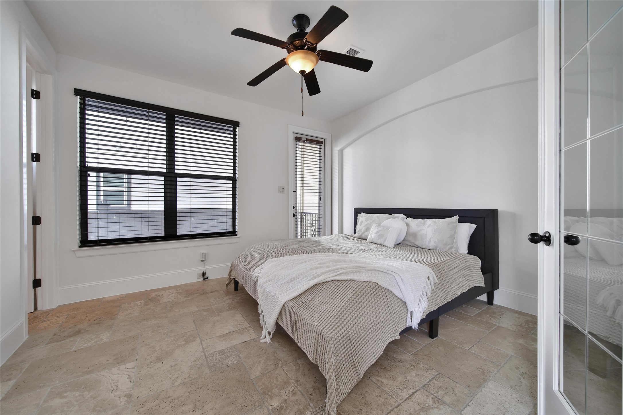 2301 Couch Street Houston, TX 77008 - Photo 6 of 22 a bedroom with a bed and a large window