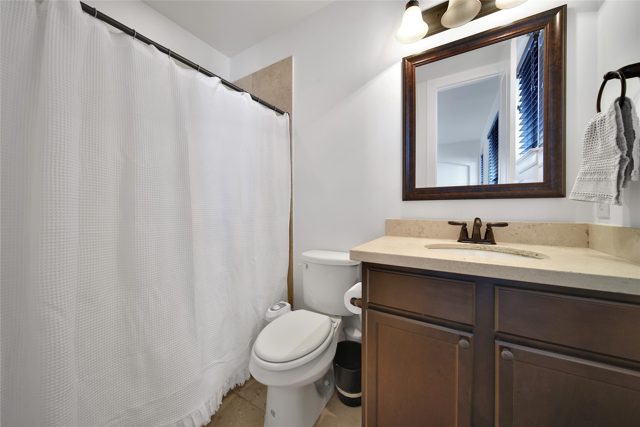 2301 Couch Street Houston, TX 77008 - Photo 7 of 22 a bathroom with a toilet sink and mirror