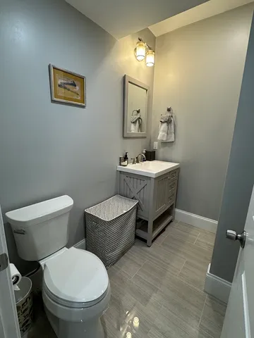a bathroom with a toilet a sink and mirror