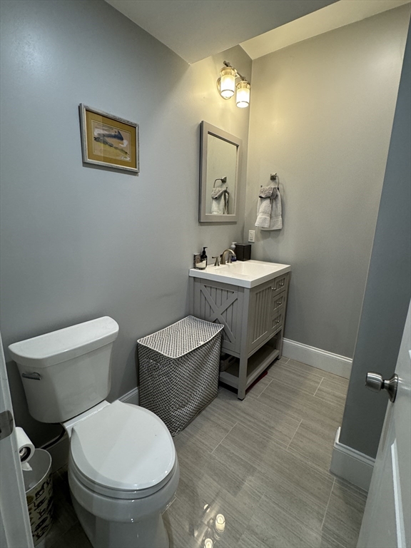 27 Dudley Street, Unit 6 Boston, MA 02119 - Photo 6 of 8 a bathroom with a toilet a sink and mirror