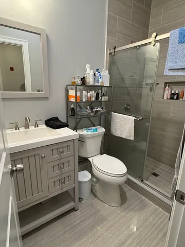 a bathroom with a sink toilet and shower