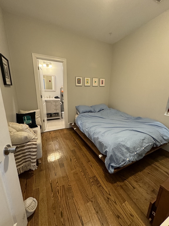 27 Dudley Street, Unit 6 Boston, MA 02119 - Photo 8 of 8 a bedroom with a bed and wooden floor