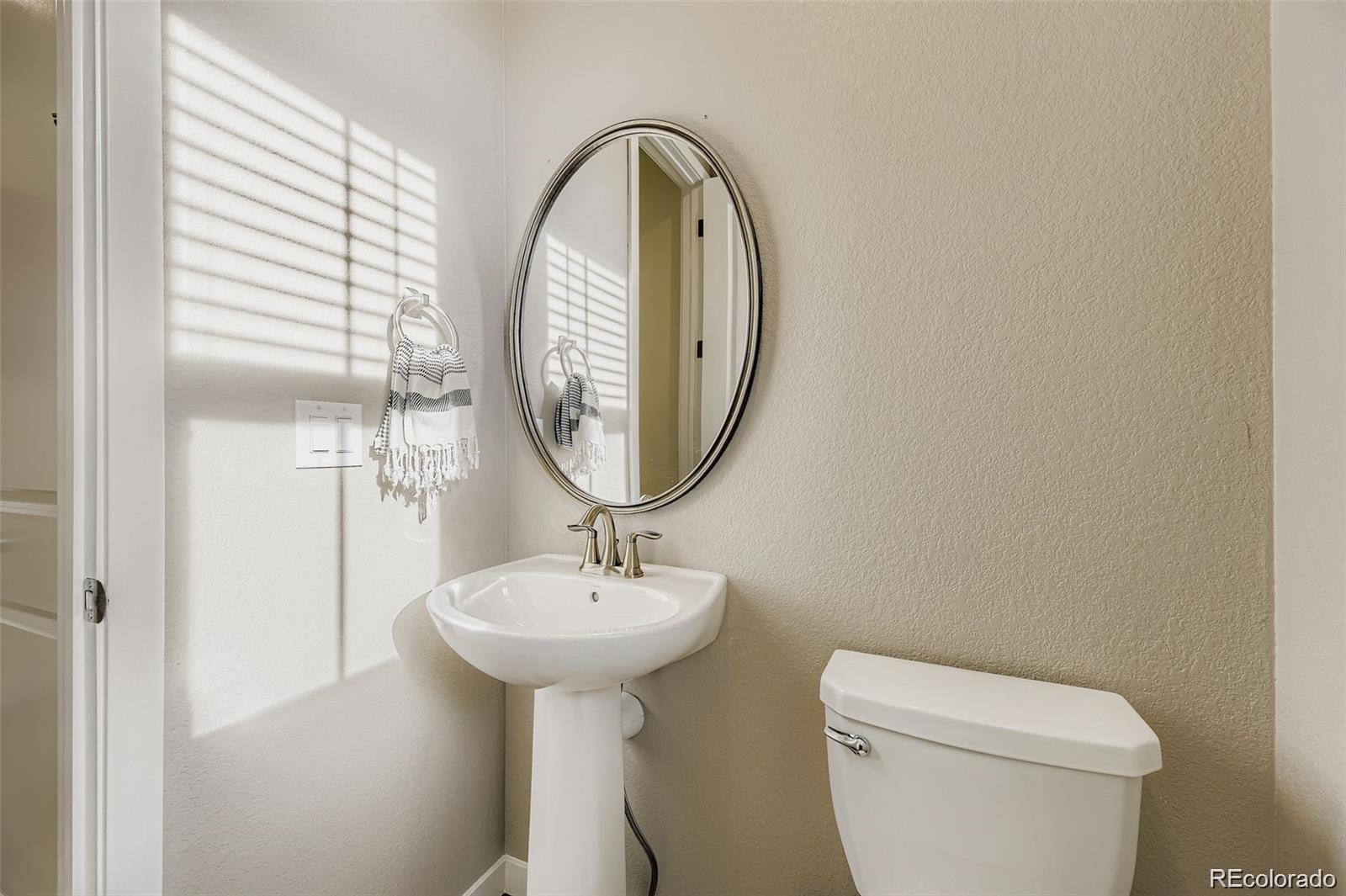 1173 Williams Loop Elizabeth, CO 80107 - Photo 11 of 30 a bathroom with a toilet sink and mirror