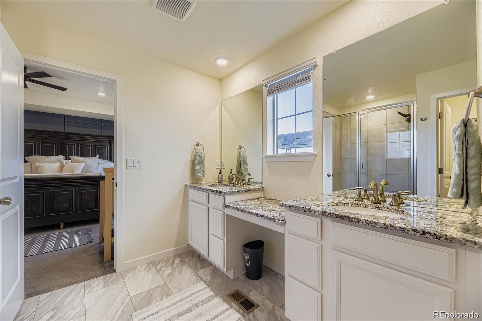 1173 Williams Loop Elizabeth, CO 80107 - Photo 16 of 30 a bathroom with a sink double vanity and a shower