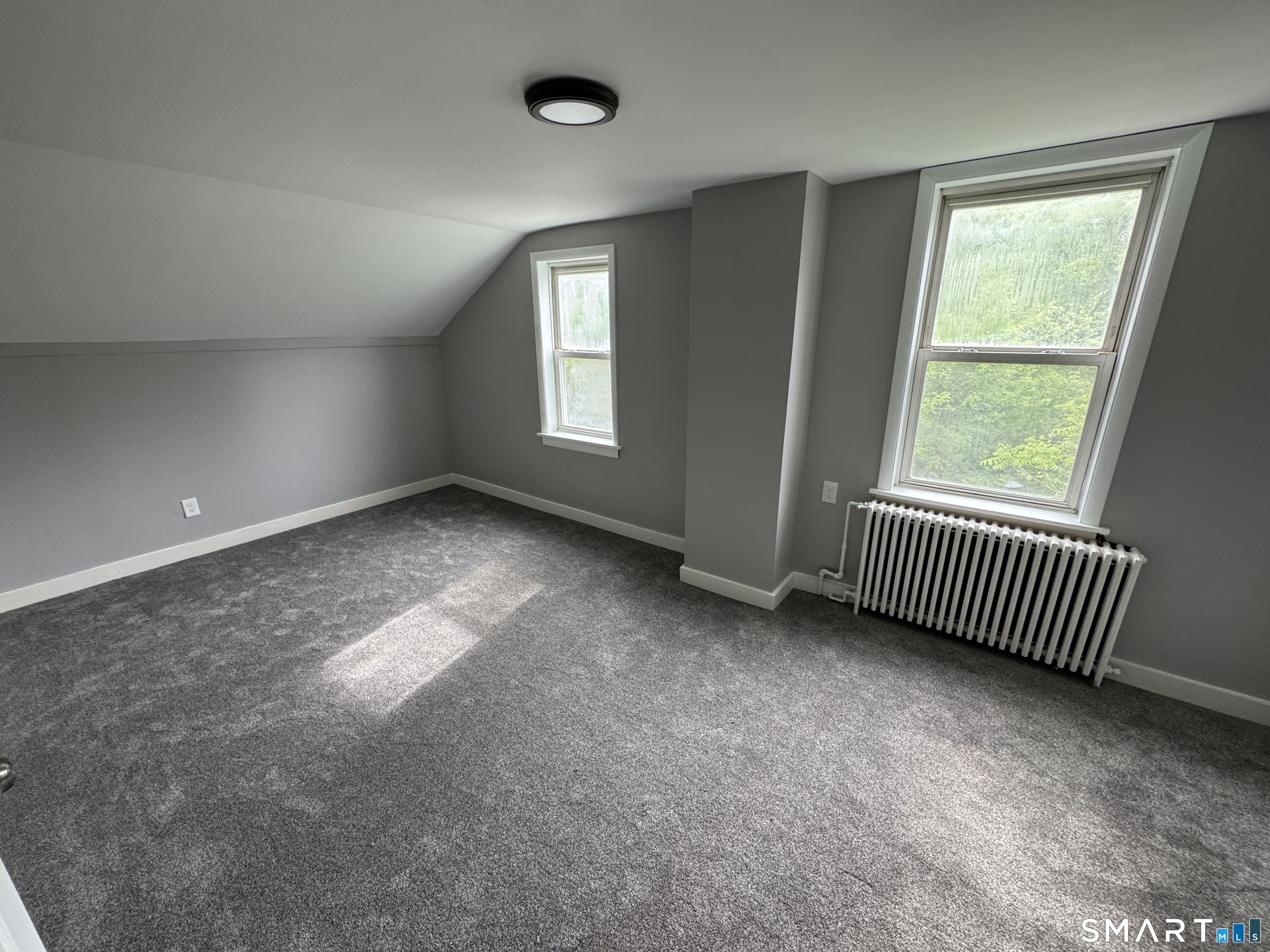 10 Center Street Windsor Locks, CT 06096 - Photo 6 of 25 an empty room with windows