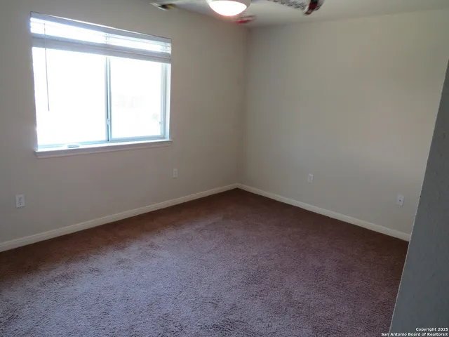 a view of an empty room and closet area