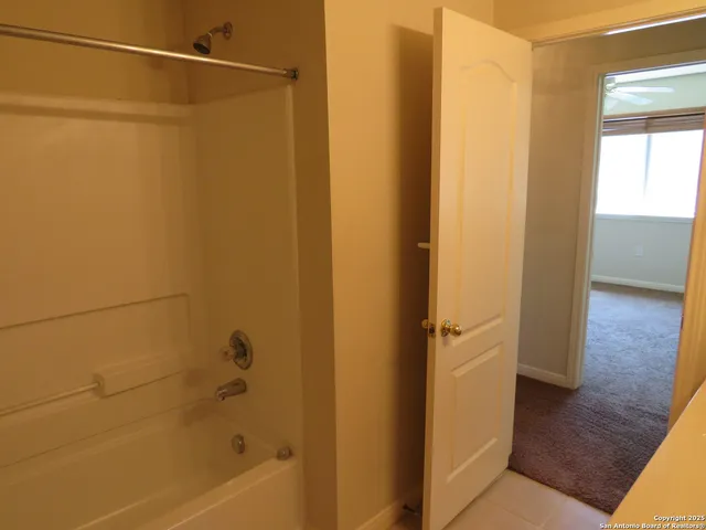 a view of a hallway with a wooden door