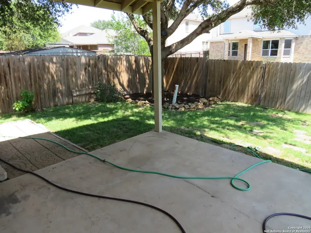 a backyard of a house with table and chairs