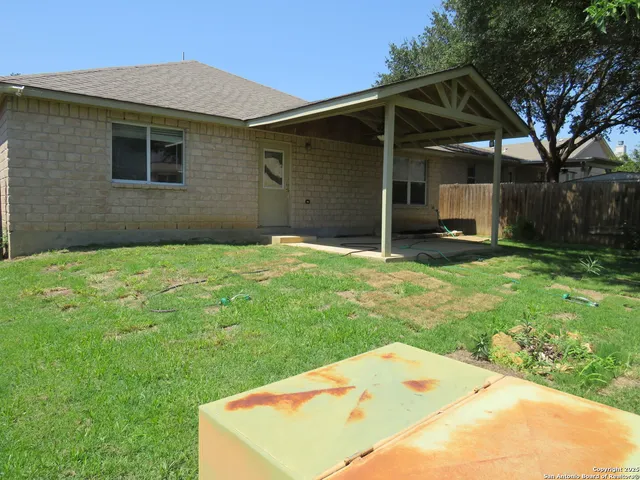 a backyard of a house with barbeque oven