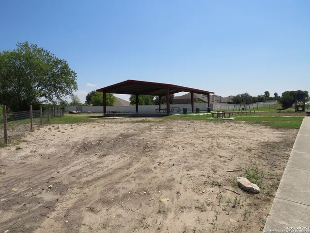 a view of yard with swimming pool and green space