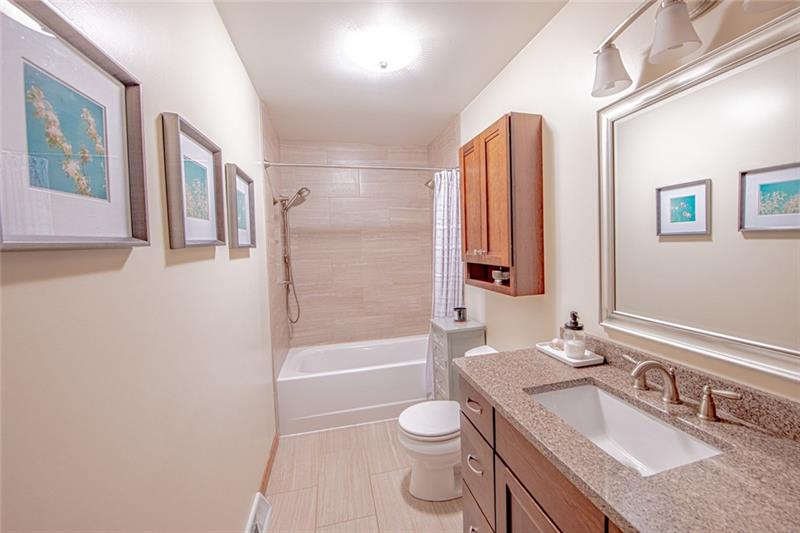 140 Stoup Road Mars, PA 16046 - Photo 18 of 25 Hall bath features a tub/shower combo complete with neutral tile and tones.