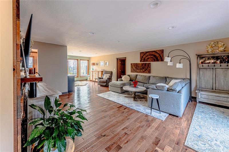 140 Stoup Road Mars, PA 16046 - Photo 3 of 25 A generously sized family room with lots of natural light and hand scraped hickory wood flooring.