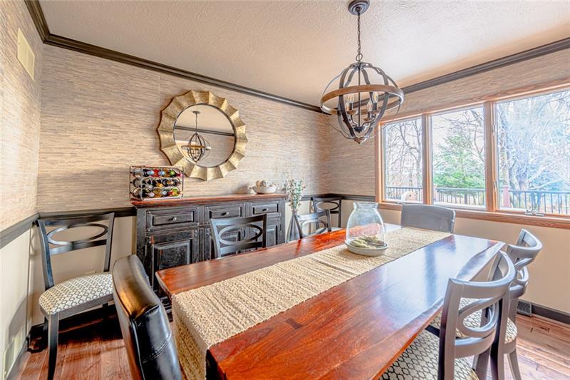 140 Stoup Road Mars, PA 16046 - Photo 10 of 25 The dining room is given character with chair rail, crown molding and grass cloth wall treatment.