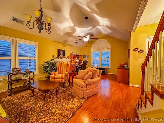 a living room with patio furniture and a chandelier