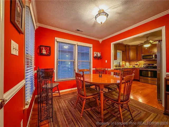 a dining room with furniture and wooden floor