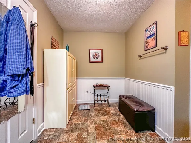 a bedroom with a bed and a rug