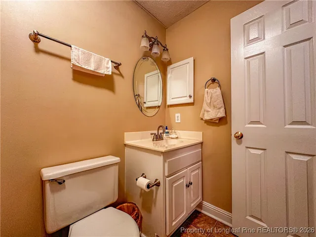 a bathroom with a sink a toilet and mirror