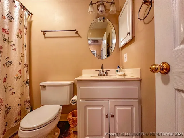 a bathroom with a sink vanity mirror and toilet