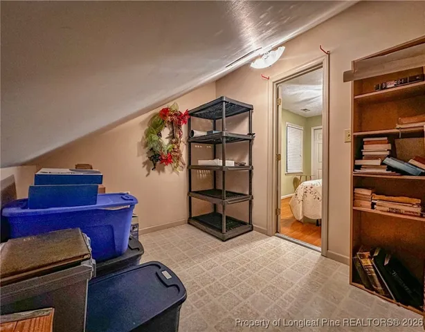 a living room with storage and a flat screen tv