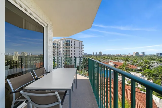 a view of a balcony with table and chairs