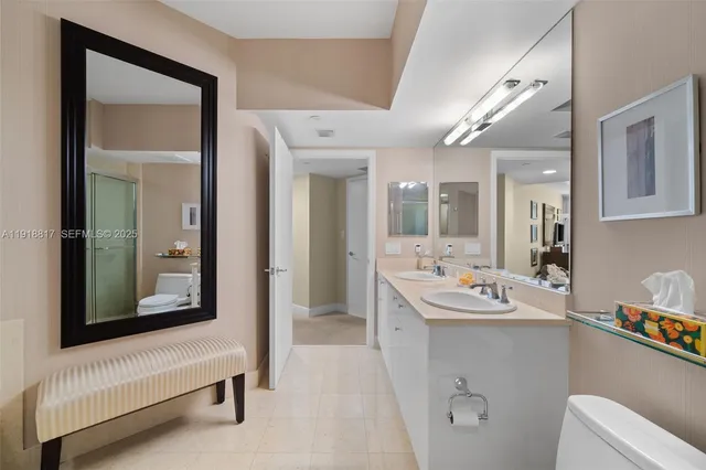 a en suite bathroom with a sink mirror and vanity