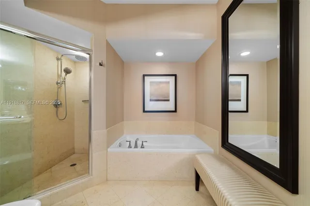 a bathroom with a bathtub and shower