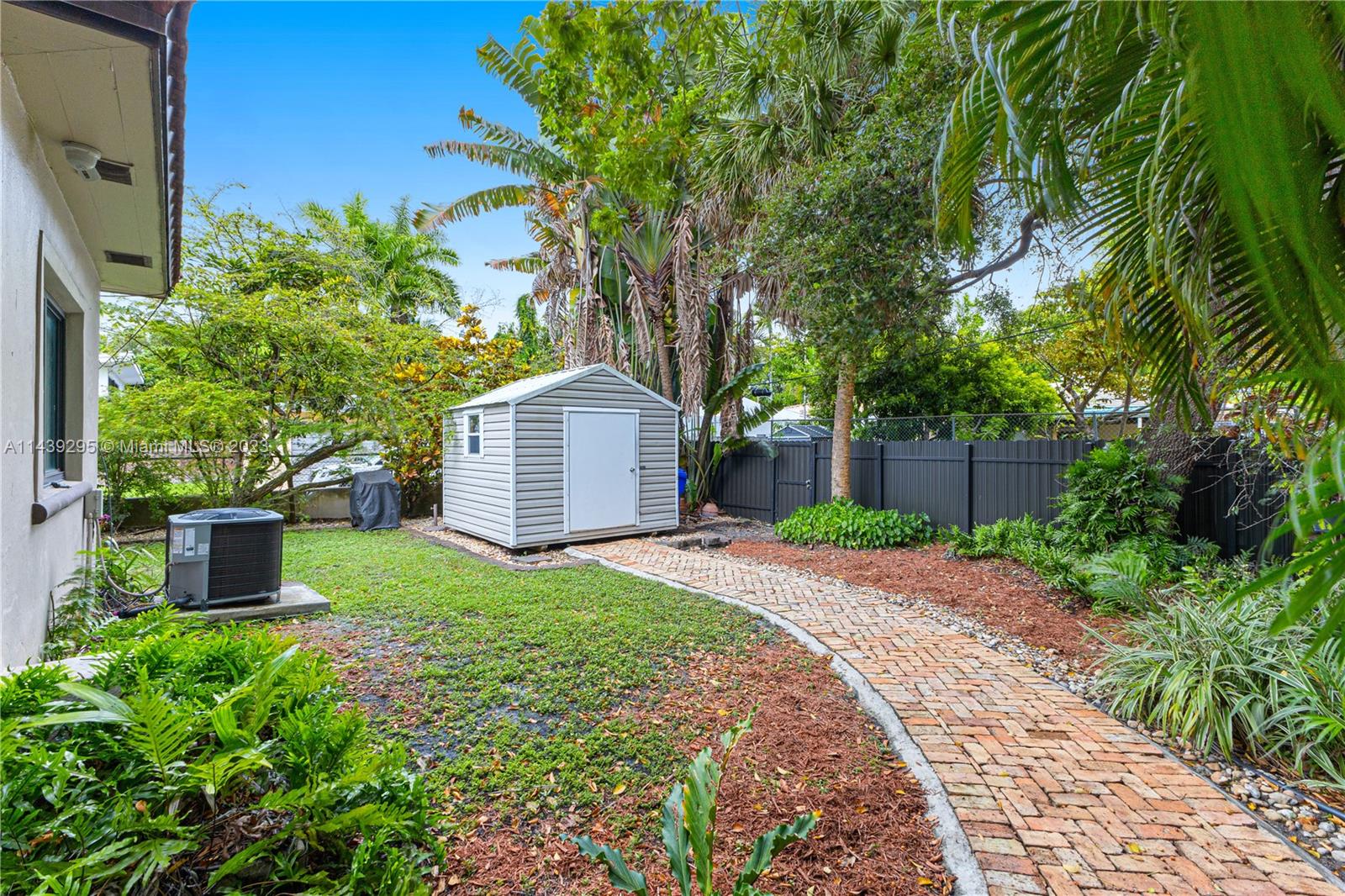 201 Southwest 24th Road Miami, FL 33129 - Photo 16 of 18 a front view of a house with a yard and a garden