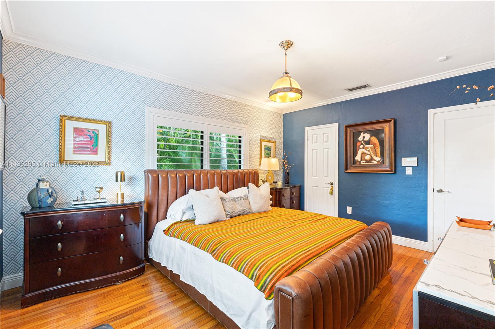 201 Southwest 24th Road Miami, FL 33129 - Photo 8 of 18 a bedroom with a bed and a chandelier