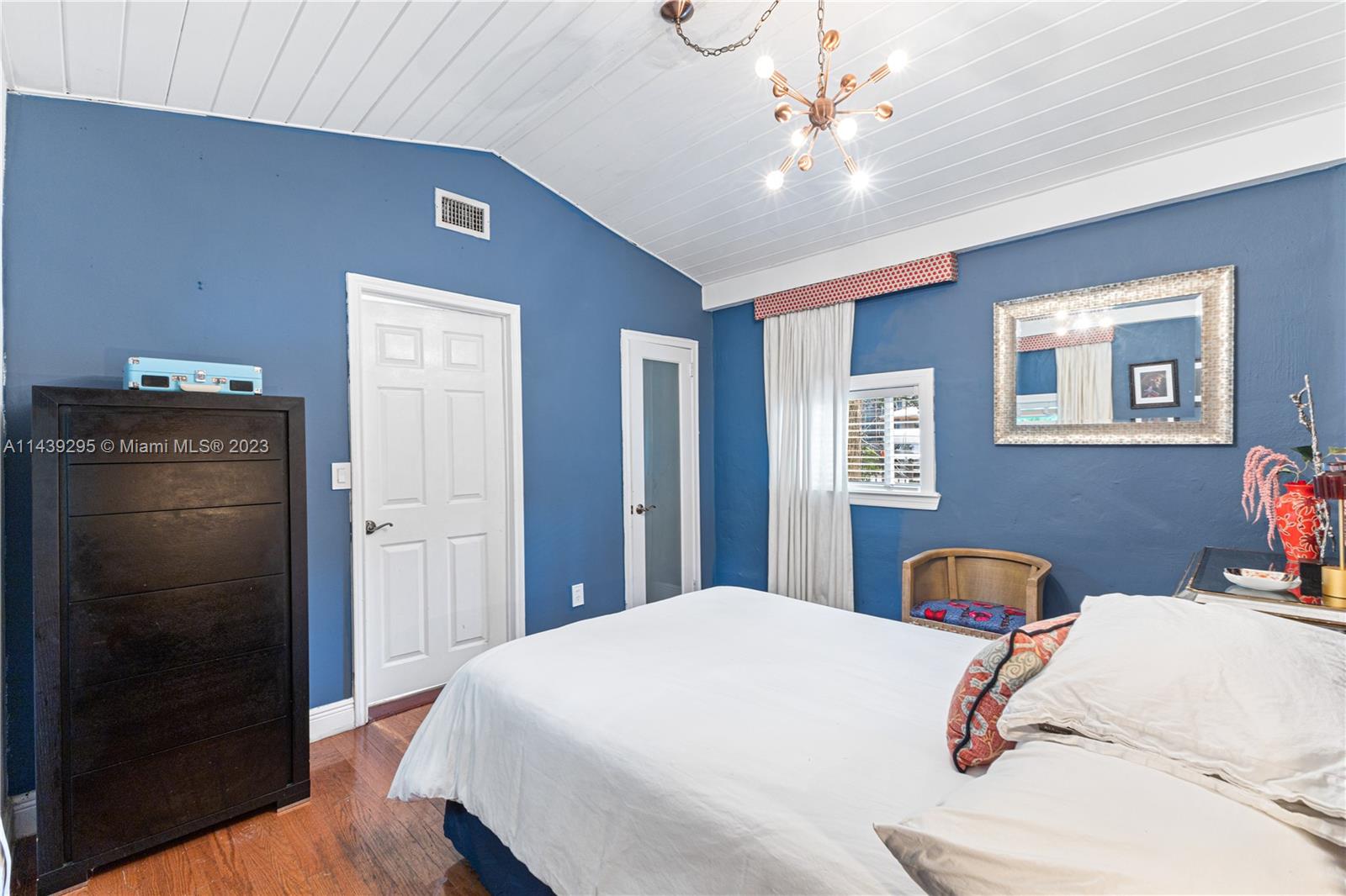 201 Southwest 24th Road Miami, FL 33129 - Photo 10 of 18 a bedroom with a bed and a chandelier