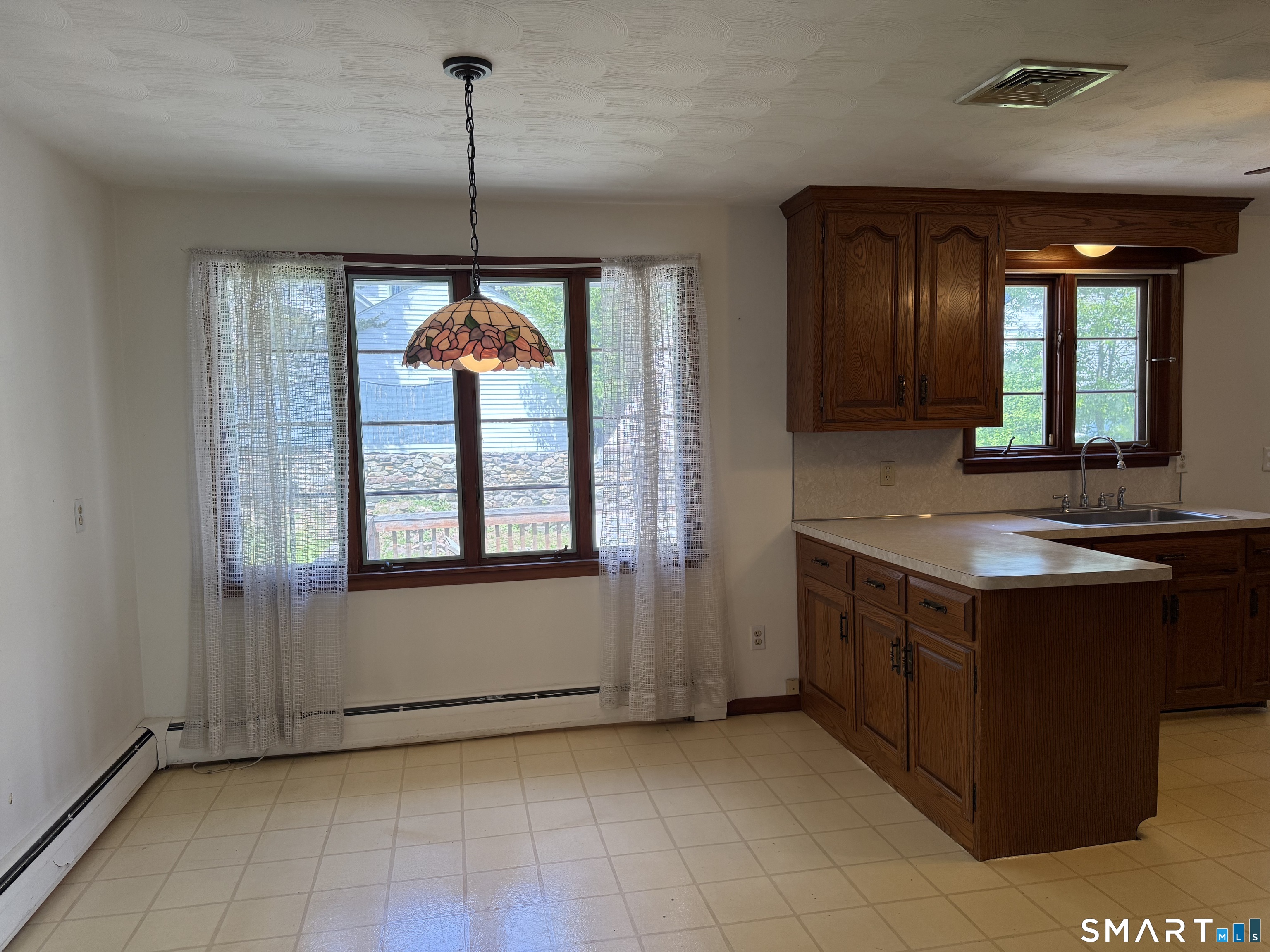 26 Maple Street Trumbull, CT 06611 - Photo 17 of 37 a view of a kitchen with kitchen island granite countertop sink and dishwasher