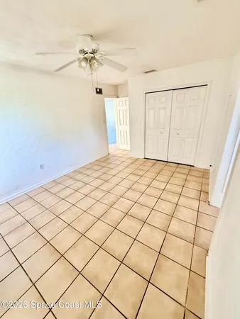 a view of a ceiling fan and window